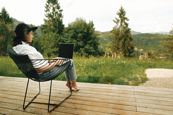 Woman sitting on porch using computer